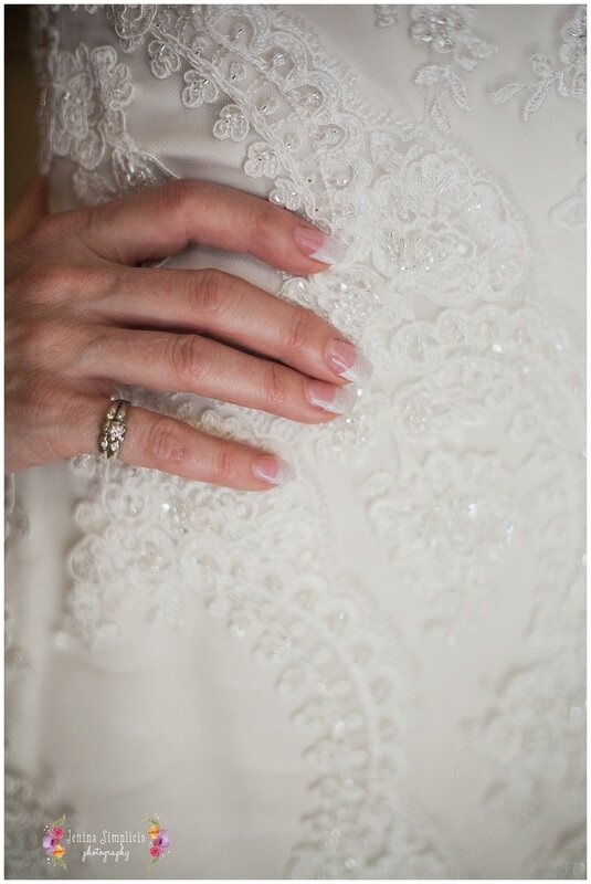  perfectly manicured hand  on the brides waist 