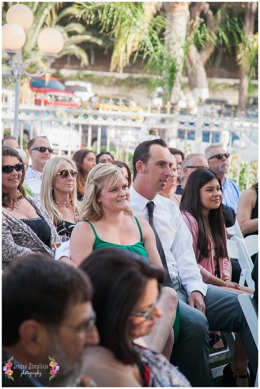  guests sitting in the garden chairs at the reception 