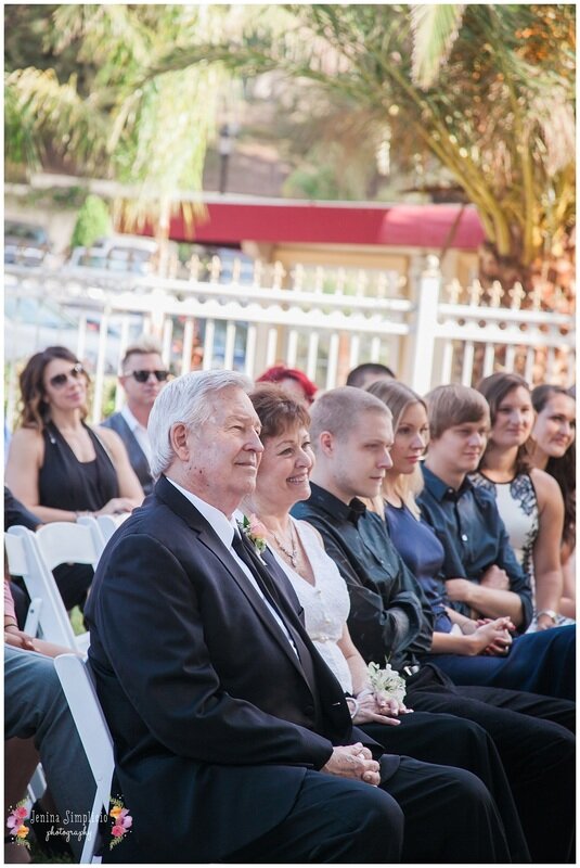  guests sitting in the garden chairs at the reception 