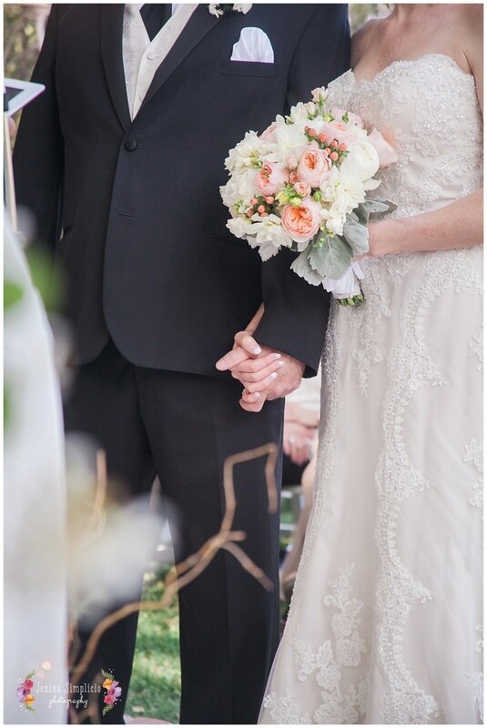  bride and grooms hands interlaced close up 