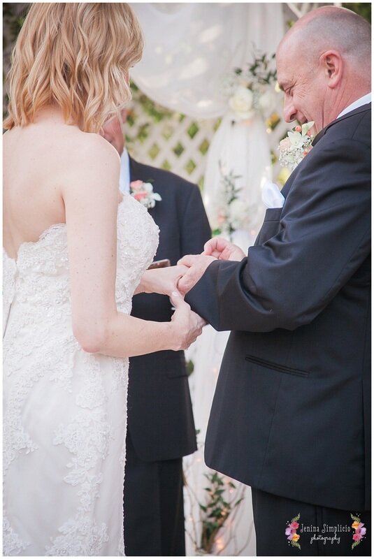  groom puts the ring on the brides finger 