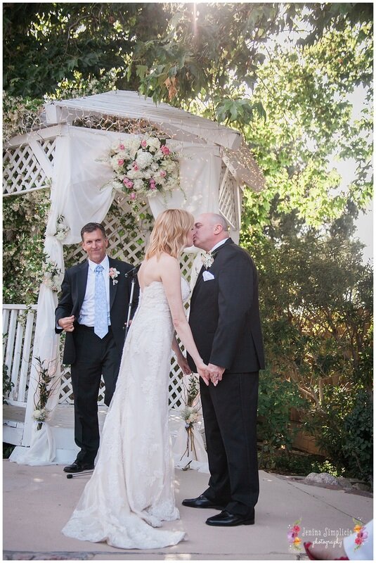  groom and bride kiss in front of gazebo 