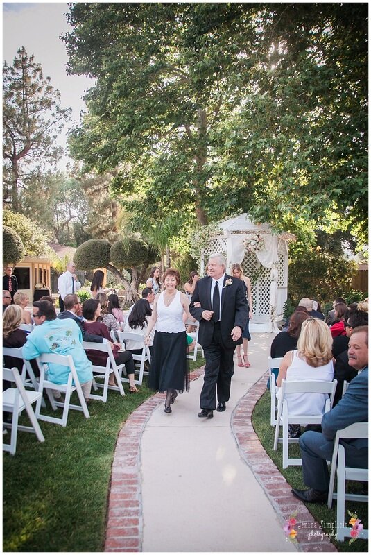  parents of the wedding party walking down the aisle 