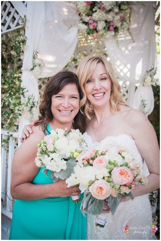  bride and maid of honor in front of a gazebo 