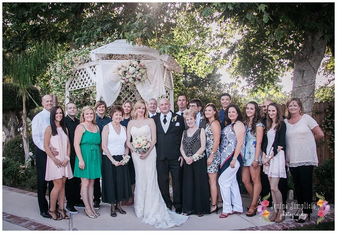  the full wedding family in front of the garden gazebo 