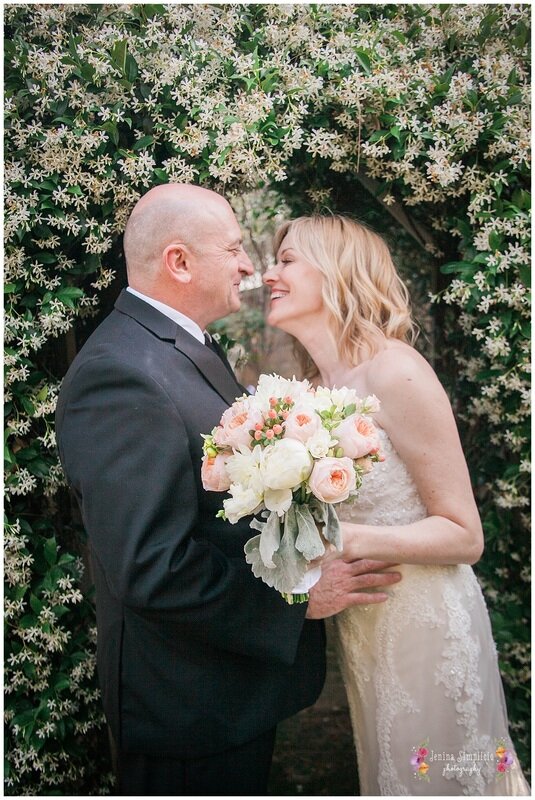  bride and groom laughing about to kiss in front of the vines 