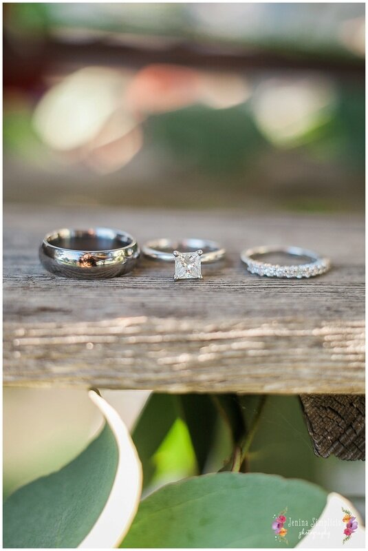  wedding bands and ring on rustic wood 