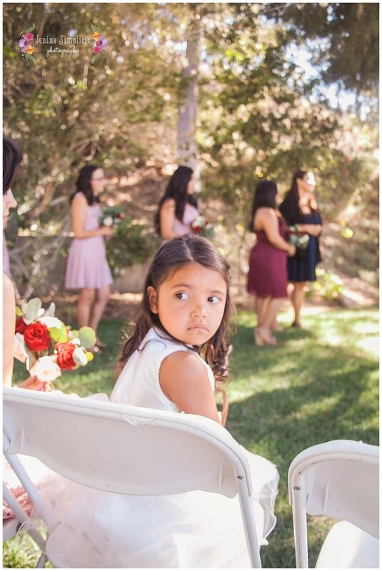  flower girl sits looking over her shoulder 