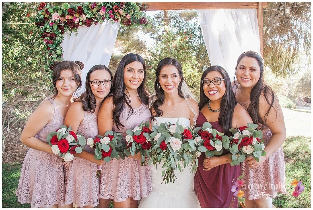  bride and maids of honor at the altar with bouquets 