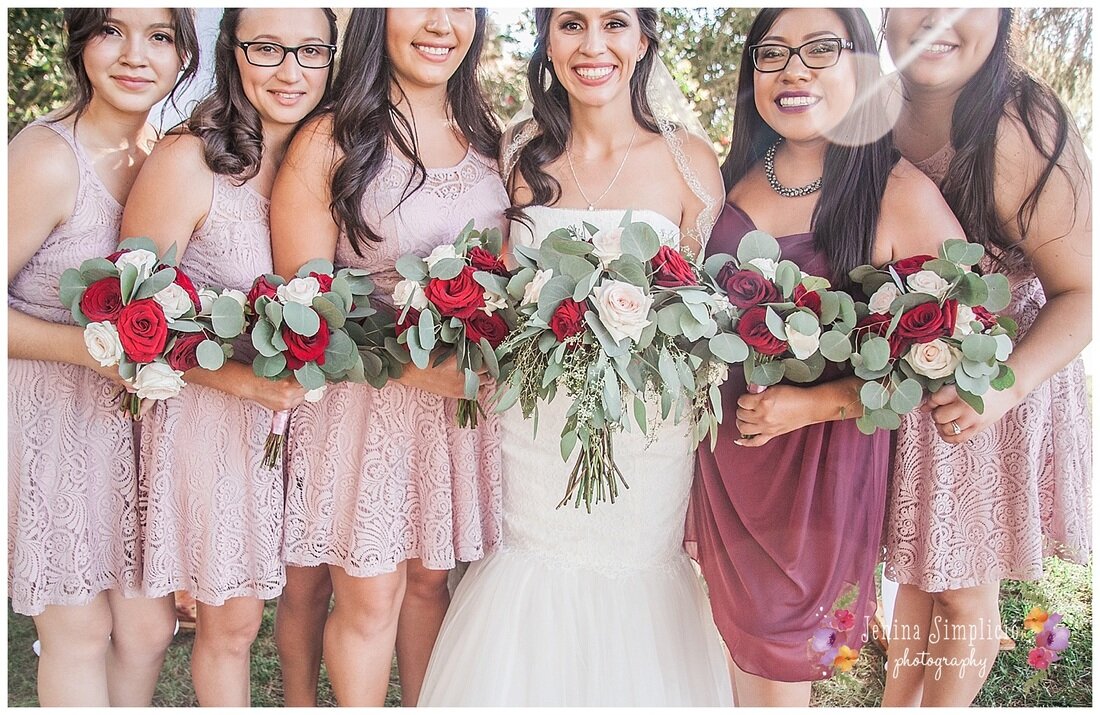  bride and maids of honor at the altar with bouquets 