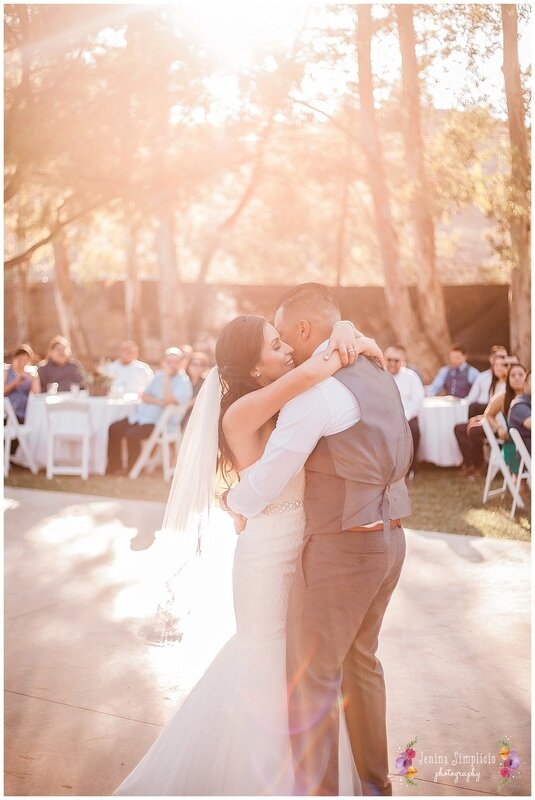  Sunlight streaming into couple during their first dance 