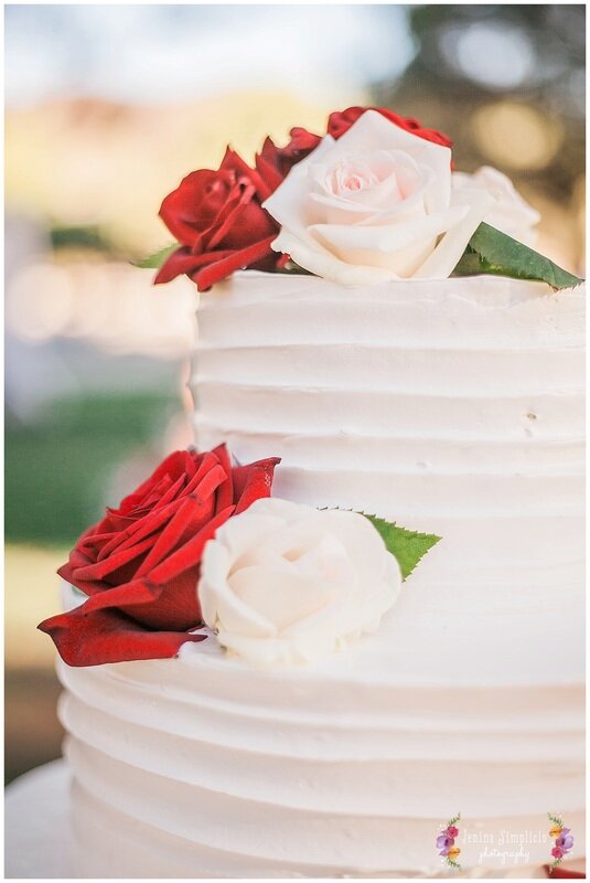  Close up of beautiful white wedding cake with roses 