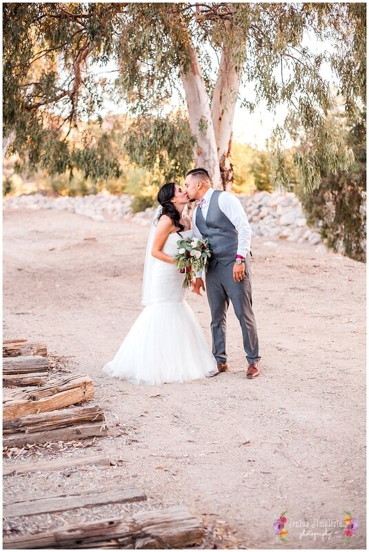  bride and groom kiss on the ranch 