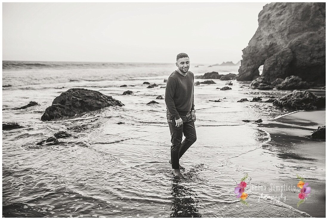  black and white photo of the groom on the beach 