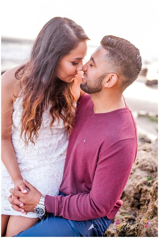  newly engaged couple on the beach at sunset 