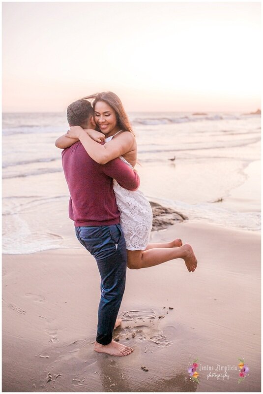  newly engaged couple on the beach at sunset 