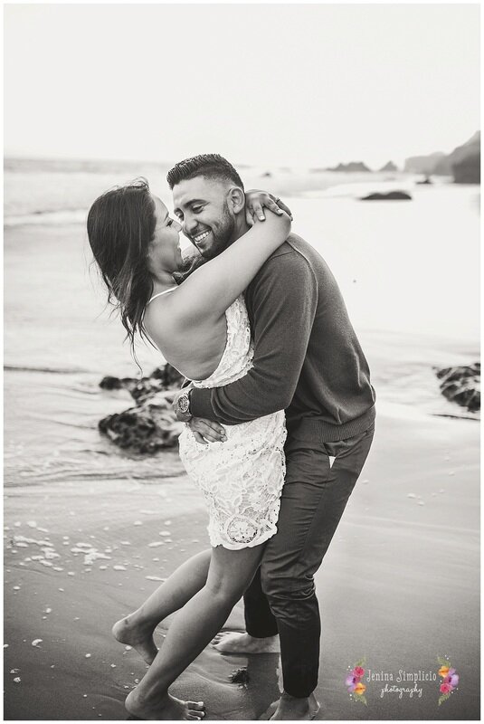  black and white photo of a newly engaged couple on the beach at sunset 