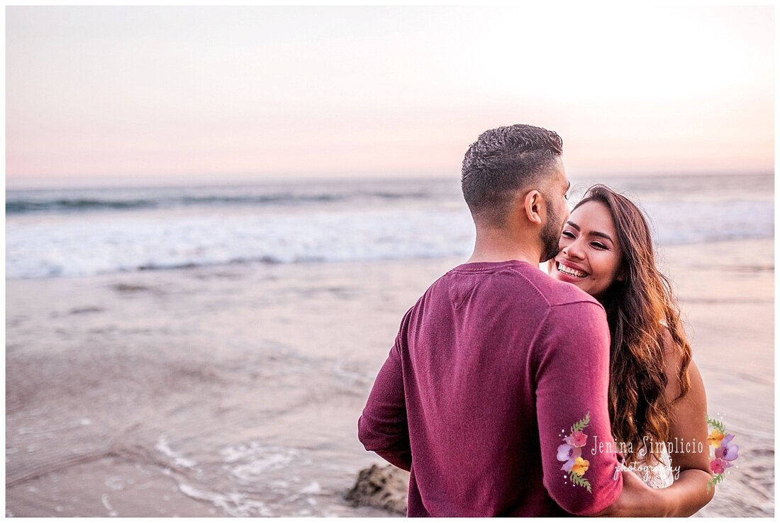  newly engaged couple on the beach at sunset 