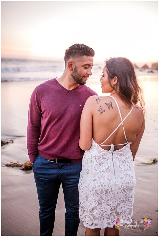  newly engaged couple together on the beach 