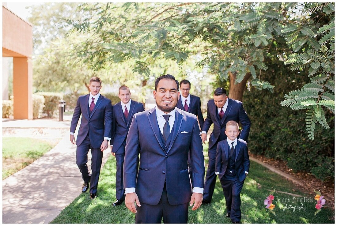  close up of the groomsmen out in the garden path 
