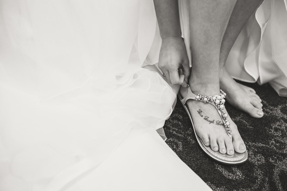  black and white photo of brides sandals 