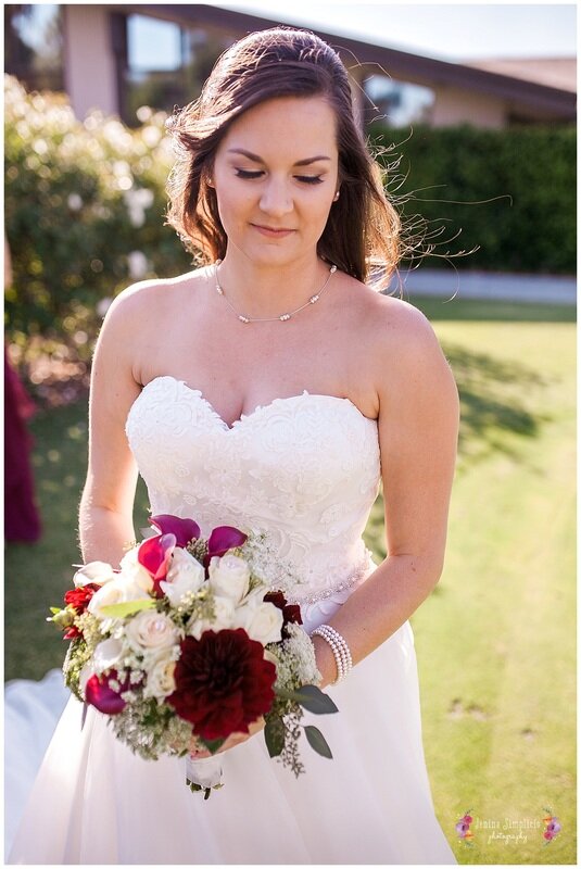  bride outside the country club with a bouquet 