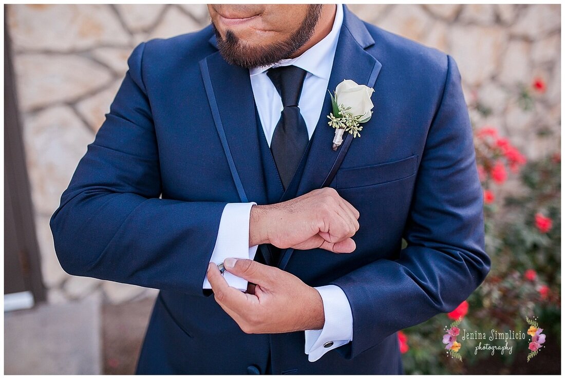  close up of groom adjusting his cufflinks 