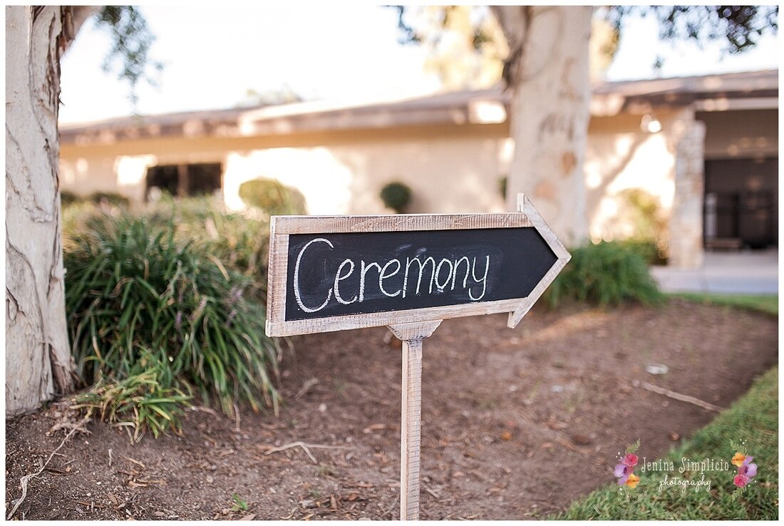 rustic sign pointing to the wedding ceremony 