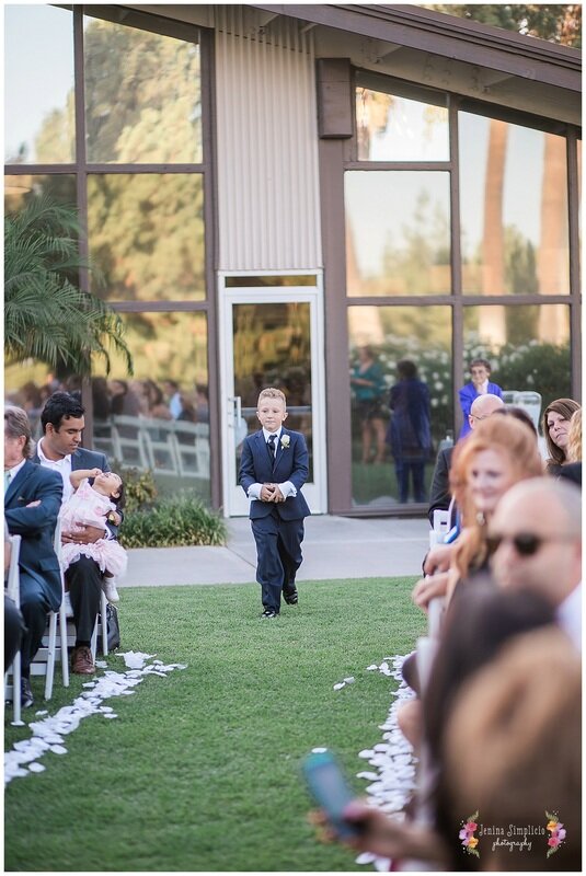  ring bearer coming down the aisle at the reception 