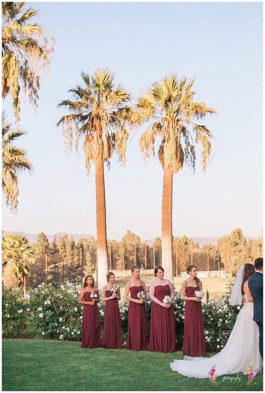  bridesmaids standing in front of the palm trees of the country club 