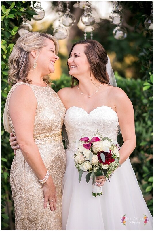  bride with her mother holding the bouquet 