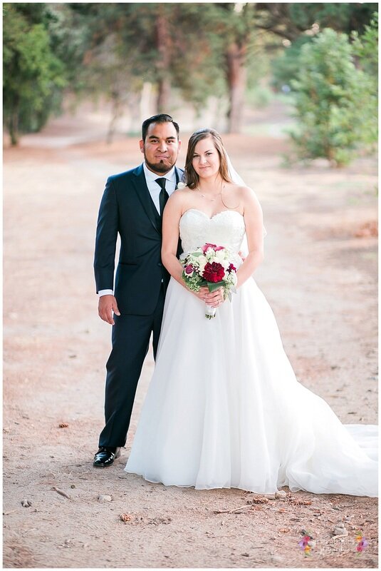  bride and groom standing together in the open dirt road 