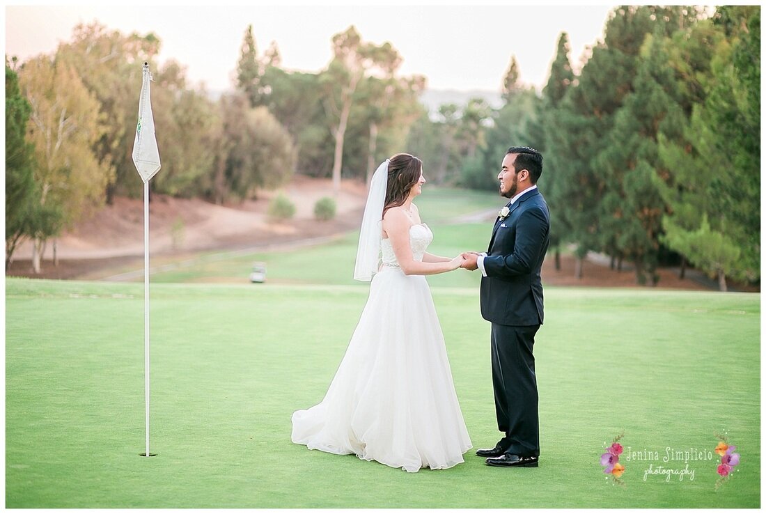  bride and groom holding hands on the golf course of the country club 