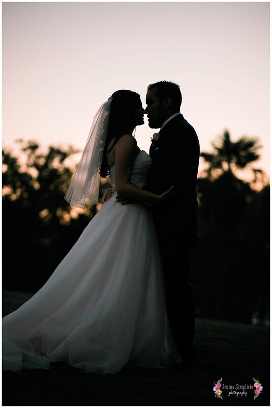  silhouettes of bride and groom embracing as the sun sets 