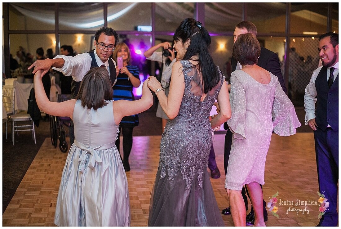  guests dancing on the dance floor with one another 