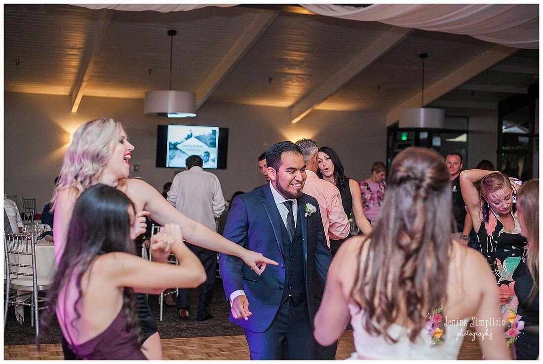  groom dancing with guests on the dance floor 