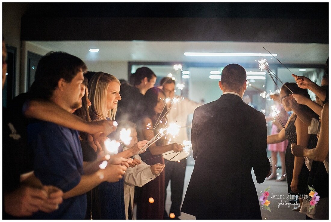  guests lighting sparklers for the bride and groom entrance 