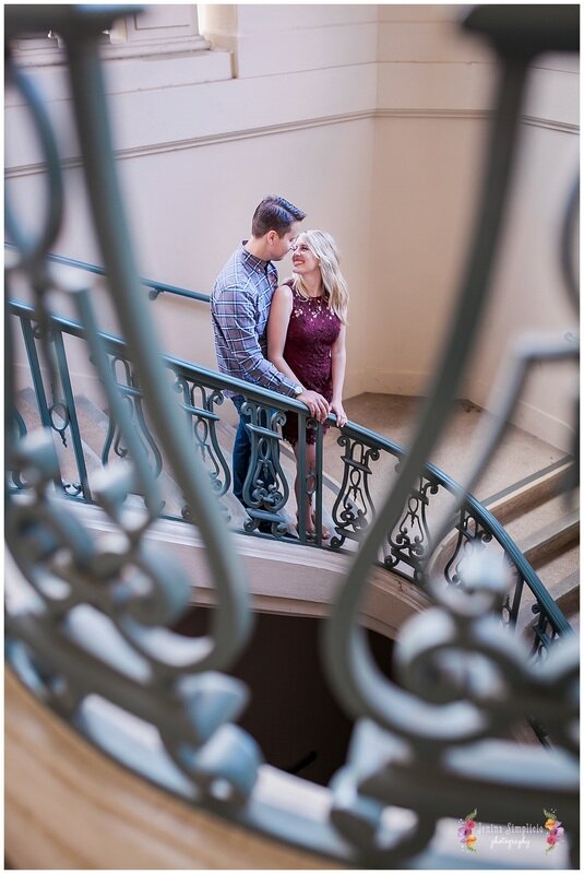  bride and groom standing on the reception hall stairs 