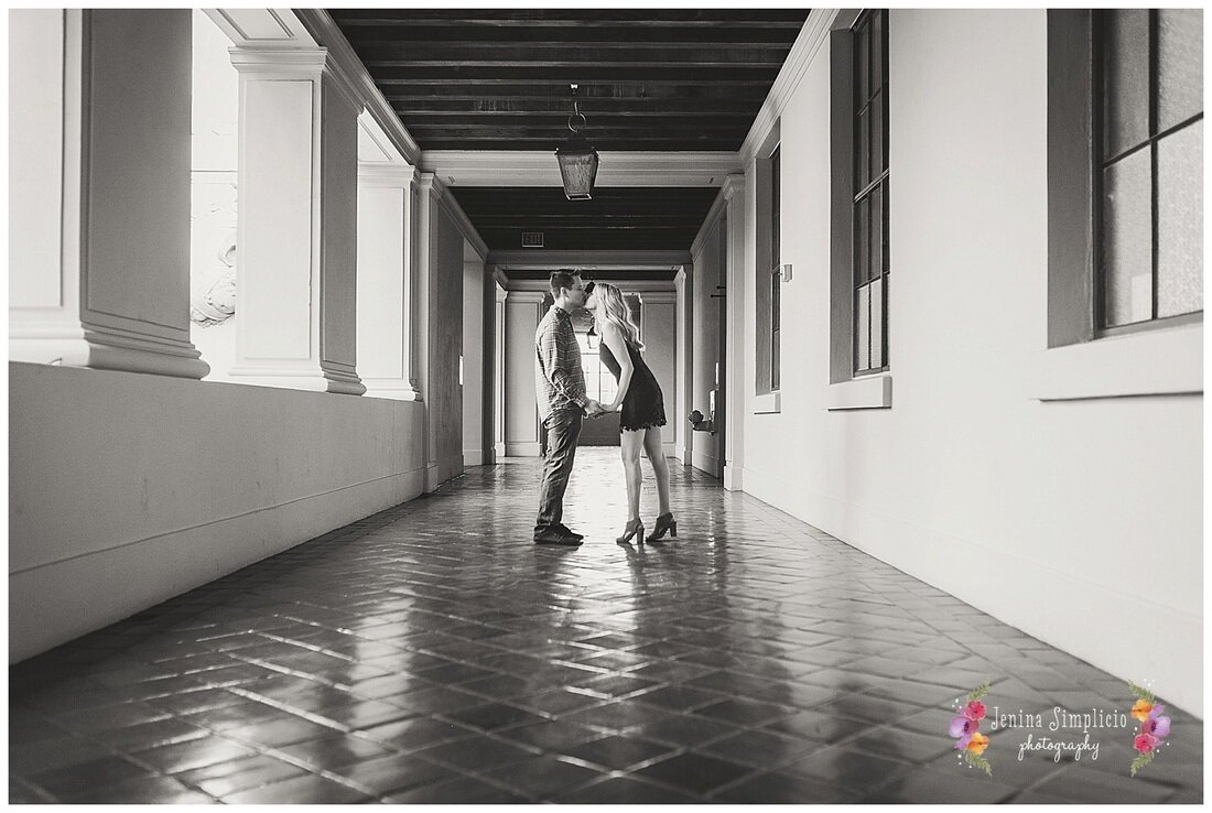  black and white photo of hallway kiss between bride and groom 