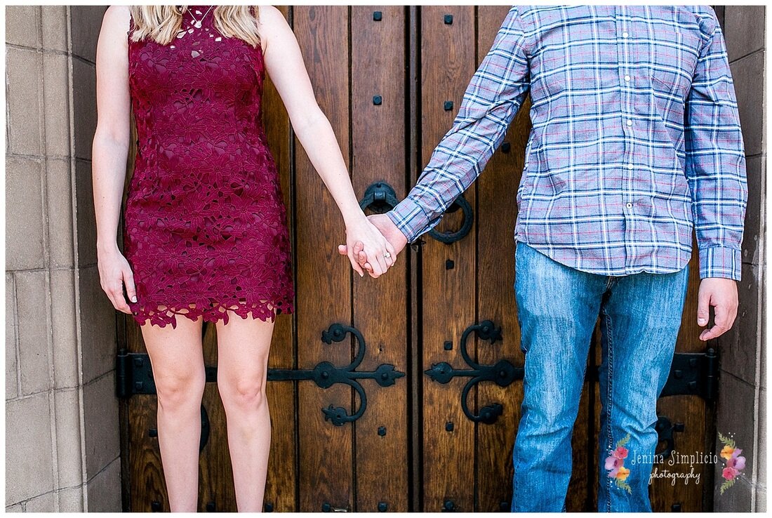  engaged couple holding hands in front of the church door 