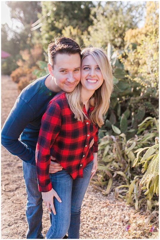  engaged couple embracing in front of the plants 