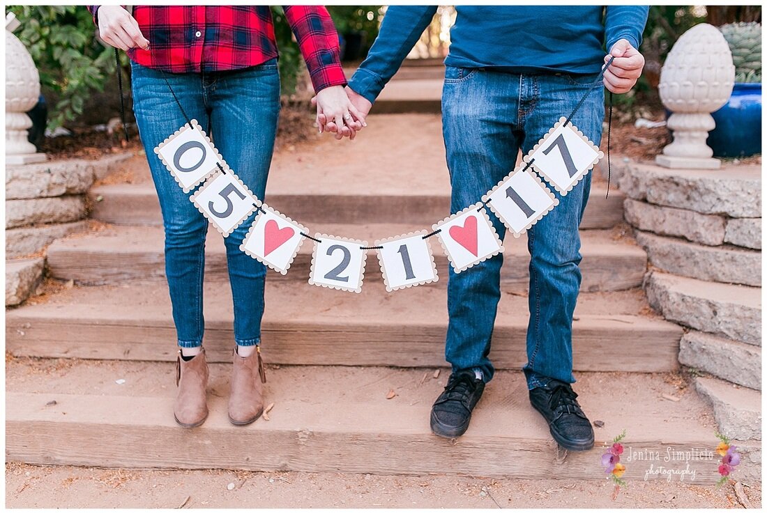  couple holding their wedding date banner 