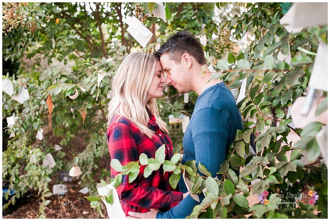  couple standing in the trees with notes around them 