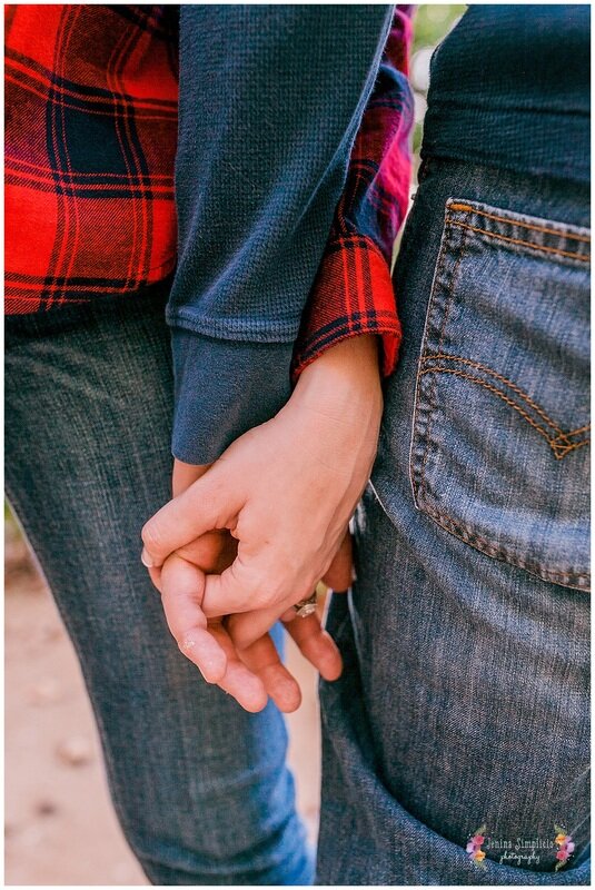  close up on newly engaged couples hands intertwined 