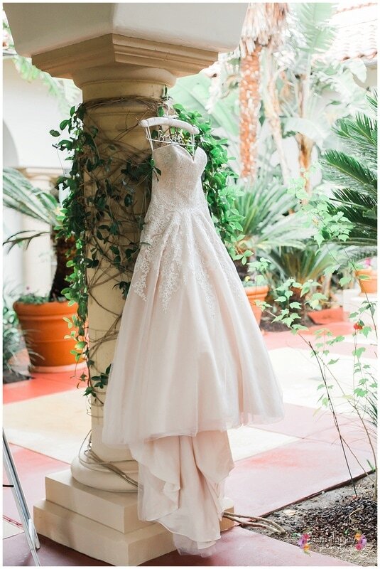  wedding dress handing on vines around a column 