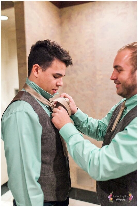  groomsmen getting their ties on 