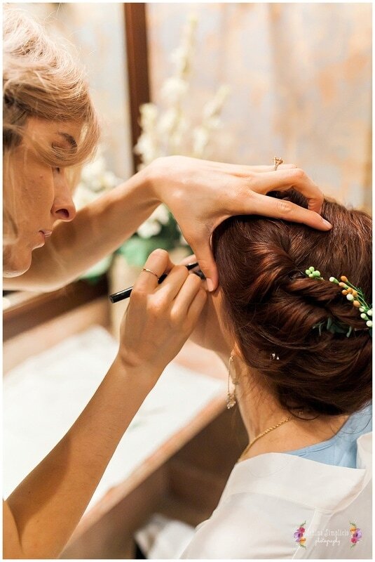  bride getting final touches on her makeup 