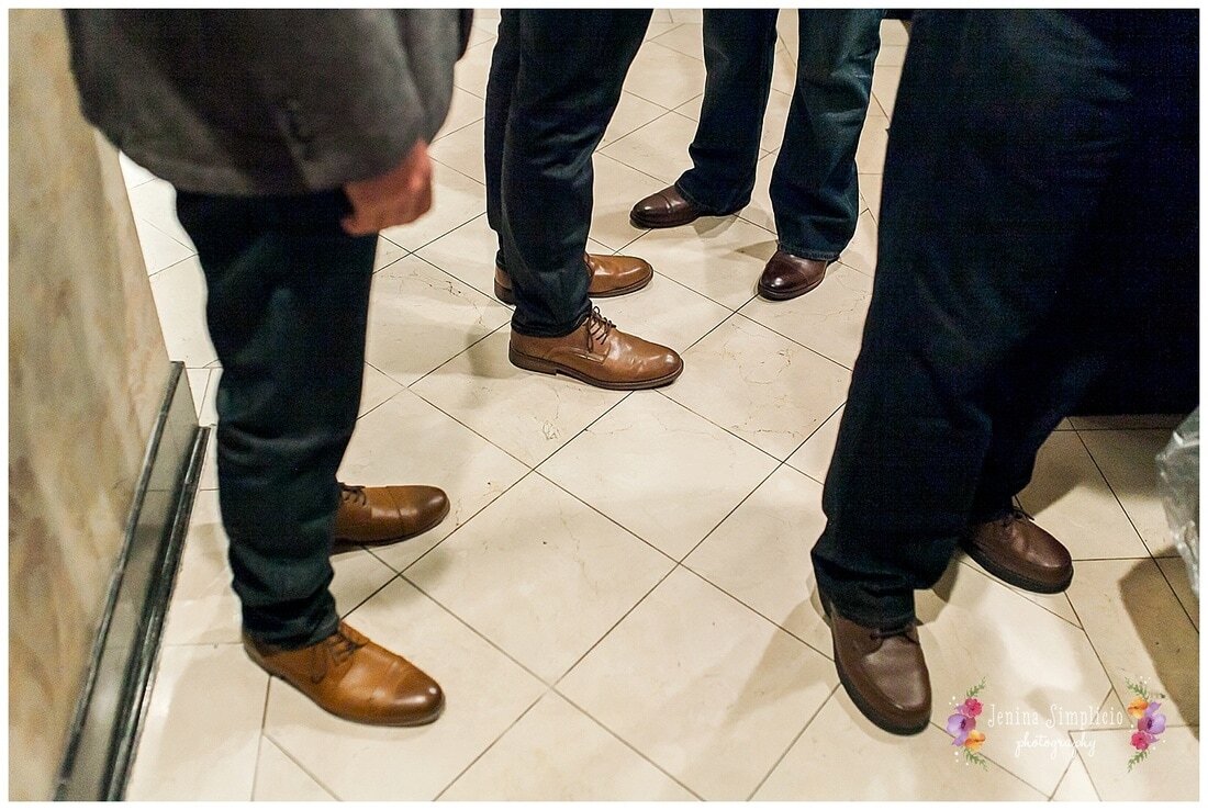  groomsmen standing in the hall getting ready 