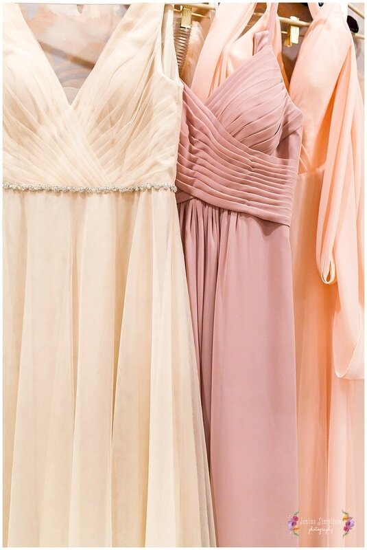  bridesmaids dresses hanging in the bridal suite 