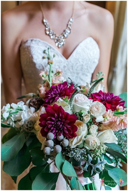  close up on bride’s bouquet in front of the dress 